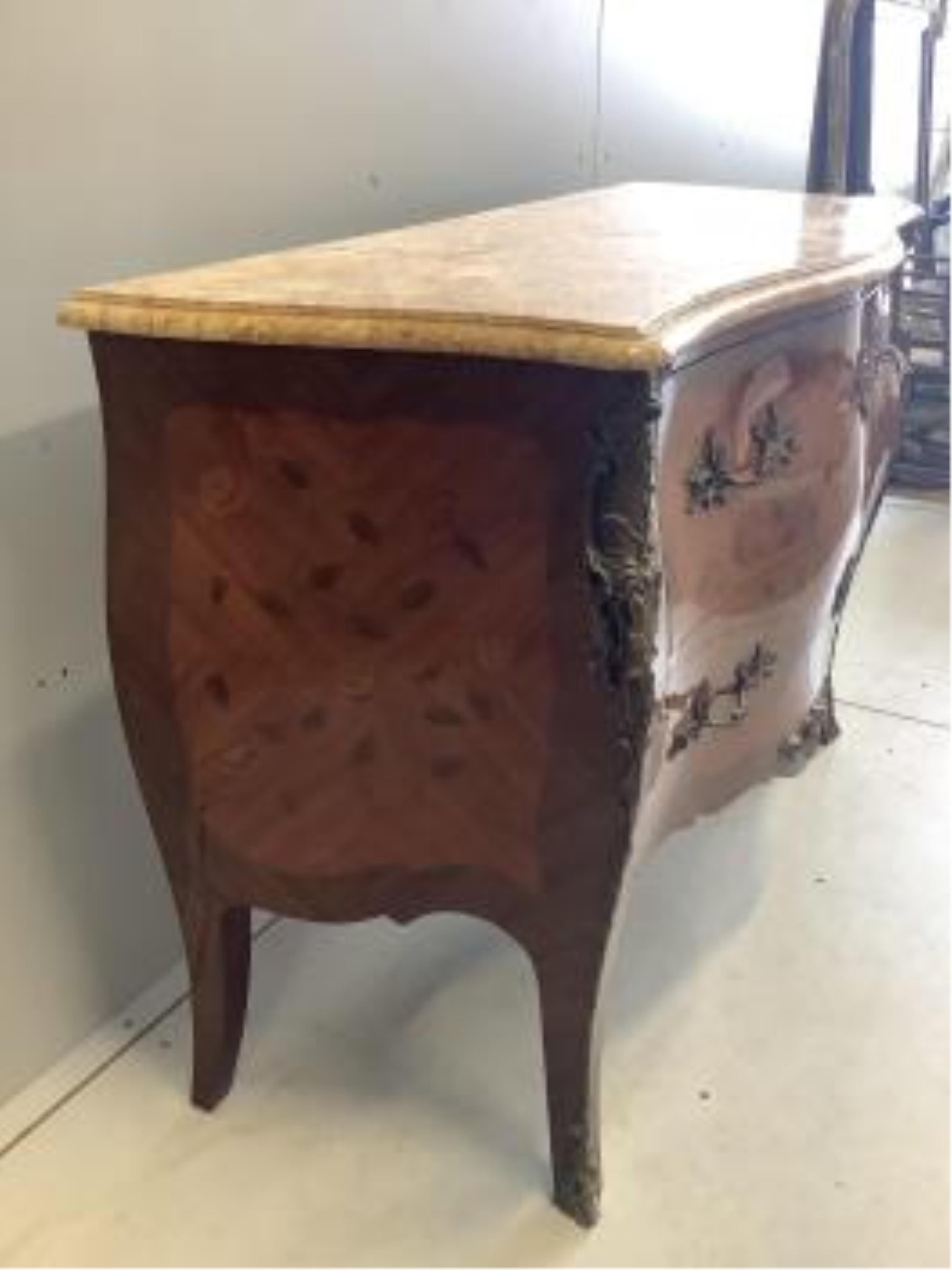 A Louis XVI style marquetry inlaid gilt metal mounted marble topped bombe commode, width 122cm, depth 51cm, height 86cm